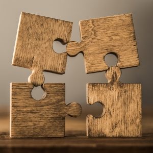 Four separate puzzle pieces implying how psychological assessments can help make sense of things.